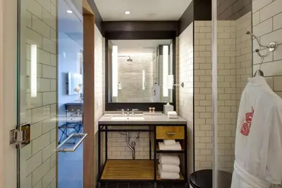 a bathroom with a sink and a mirror at Hotel 50 Bowery, part of JdV by Hyatt in New York