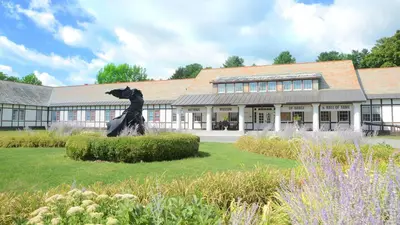a statue of a dog in front of a building at Holiday Inn Saratoga Springs by IHG in Saratoga Springs