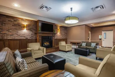 a lobby with couches and a fireplace at Holiday Inn Saratoga Springs by IHG in Saratoga Springs