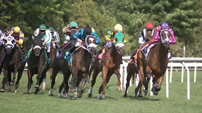 a group of horses racing on a track at Holiday Inn Saratoga Springs by IHG in Saratoga Springs