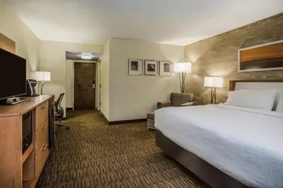 a hotel room with a bed and a flat screen tv at Holiday Inn Saratoga Springs by IHG in Saratoga Springs