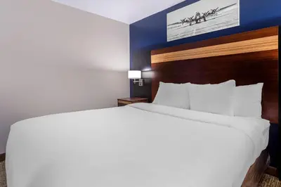 a large white bed in a hotel room at Avion Inn Near LGA Airport, an Ascend Collection Hotel in Queens