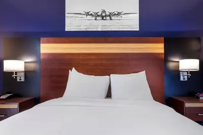 a bed in a hotel room with a large white bed at Avion Inn Near LGA Airport, an Ascend Collection Hotel in Queens