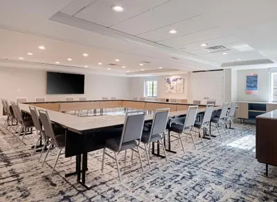 a conference room with a long table and chairs at Homewood Suites by Hilton Parsippany-Troy Hills in Parsippany