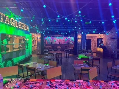 a restaurant with tables and chairs and a bus at Holiday Inn & Suites Parsippany Fairfield by IHG in Parsippany