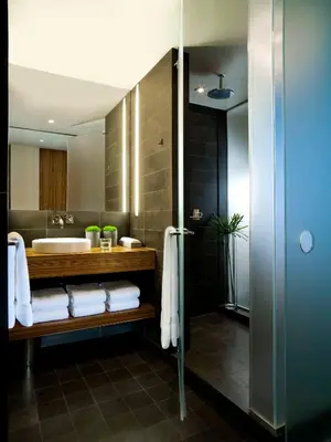 a bathroom with a sink and a tub and towels at Sixty LES in New York