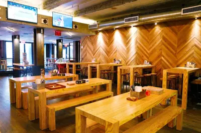 a restaurant with wooden tables in a room at Pod 51 in New York