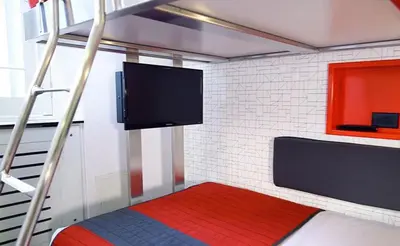 a room with a bunk bed with a flat screen tv at Pod 51 in New York