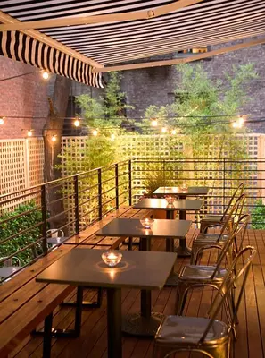 a restaurant with tables and chairs on a deck at Pod 51 in New York
