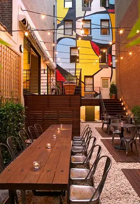 a wooden table and chairs on a patio at Pod 51 in New York