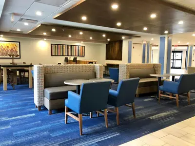 a waiting room with tables and chairs in a hospital at Holiday Inn Express Great Barrington by IHG in Great Barrington