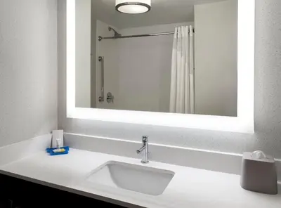 a bathroom with a sink and a large mirror at Holiday Inn Express Great Barrington by IHG in Great Barrington