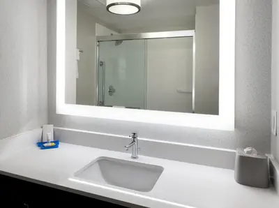 a bathroom with a sink and a large mirror at Holiday Inn Express Great Barrington by IHG in Great Barrington