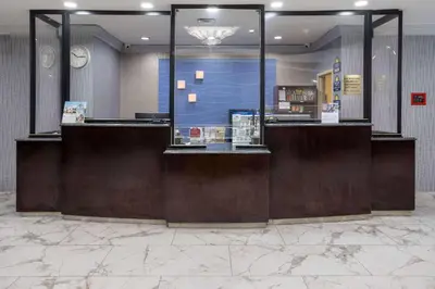a lobby of a store with a reception desk at Days Hotel by Wyndham North Bergen in North Bergen