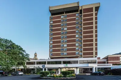a hotel building with a parking lot in front of it at Holiday Inn & Suites Pittsfield-Berkshires by IHG in Pittsfield