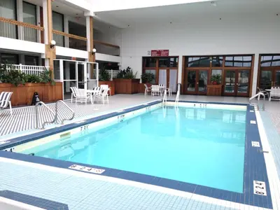 a large swimming pool in front of a building at Holiday Inn & Suites Pittsfield-Berkshires by IHG in Pittsfield