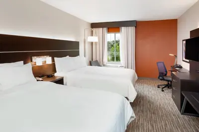 a hotel room with two beds and a television at Holiday Inn Express Haskell-Wayne Area by IHG in Haskell