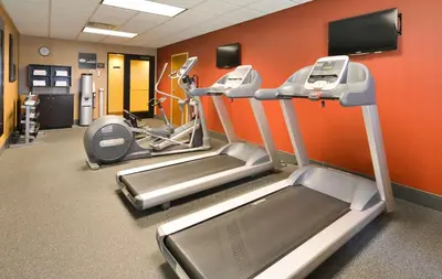 a gym with two treadmills and a treadmill at Hampton Inn Utica in Utica