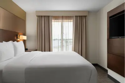 a hotel room with a large white bed and a window at Residence Inn by Marriott Kingston in Kingston