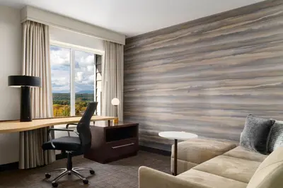 a hotel room with a desk and a couch at Residence Inn by Marriott Kingston in Kingston