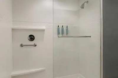 a white shower with a glass shower door at Residence Inn by Marriott Kingston in Kingston