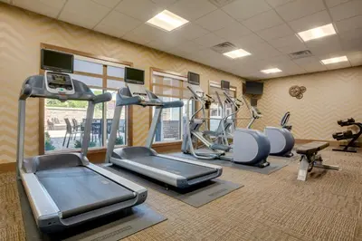 a gym with treadmills and ellipticals in a room at Residence Inn by Marriott Kingston in Kingston