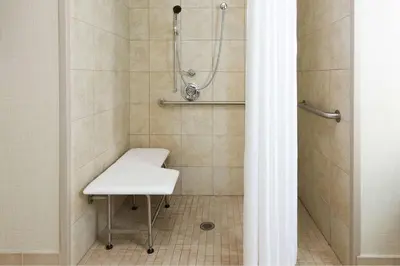 a bathroom with a shower with a white sink at Homewood Suites by Hilton Holyoke-Springfield/North in Holyoke