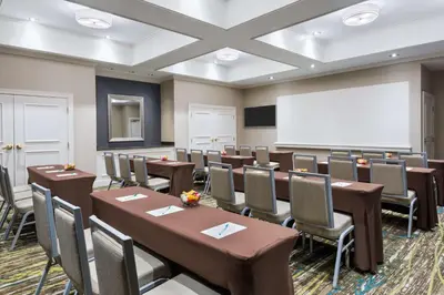 a conference room with tables and chairs and a whiteboard at Homewood Suites by Hilton Holyoke-Springfield/North in Holyoke