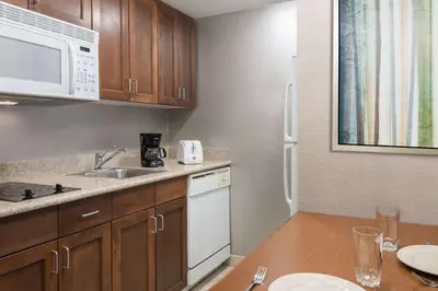 a kitchen with a sink and a microwave at Homewood Suites by Hilton Holyoke-Springfield/North in Holyoke