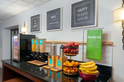 a counter with fruit in baskets on top of it at Hampton Inn Danbury in Danbury