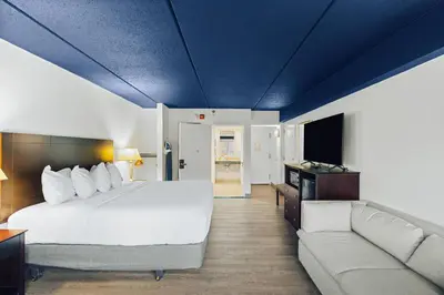 a hotel room with a bed and a couch at Hotel Downstreet, an Ascend Collection Hotel in North Adams