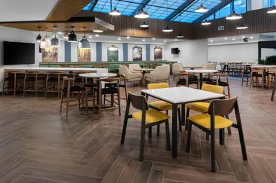 a restaurant with tables and chairs in a room at Fairfield Inn & Suites Springfield Enfield in Springfield