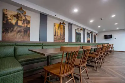 a bar with a row of tables and chairs at Fairfield Inn & Suites Springfield Enfield in Springfield