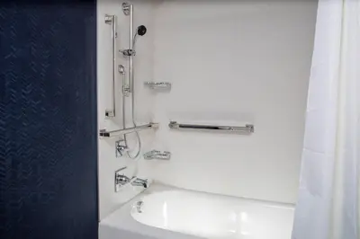 a white bathroom with a shower and a sink at Fairfield Inn & Suites Springfield Enfield in Springfield