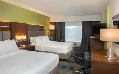 a hotel room with two beds and a television at Holiday Inn Express Hotel & Suites Clifton Park by IHG in Clifton Park