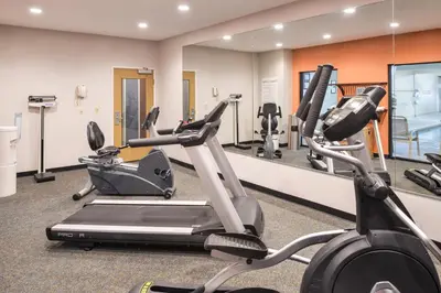 a gym with two exercise bikes and a mirror at Holiday Inn Express Hotel & Suites Clifton Park by IHG in Clifton Park