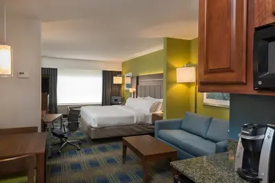a hotel room with a bed and a desk at Holiday Inn Express Hotel & Suites Clifton Park by IHG in Clifton Park