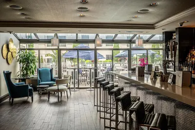 a restaurant with a bar with chairs and umbrellas at The Inn At Fox Hollow Hotel in Woodbury