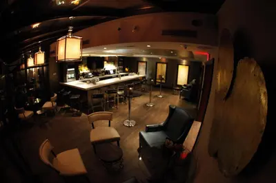an overhead view of a room with a bar and chairs at The Inn At Fox Hollow Hotel in Woodbury