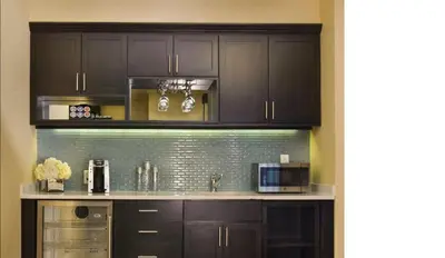 a kitchen with dark brown cabinets and a counter at The Inn At Fox Hollow Hotel in Woodbury