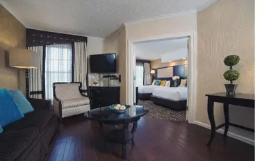 a hotel room with a couch and a bed at The Inn At Fox Hollow Hotel in Woodbury
