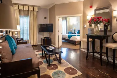 a living room with a couch and a bed at The Inn At Fox Hollow Hotel in Woodbury
