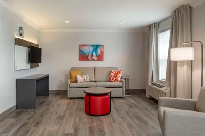 a living room with a couch and a table at Comfort Inn & Suites Hadley - Amherst in Hadley