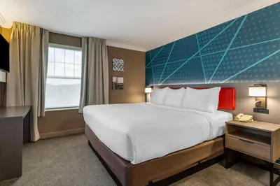 a hotel room with a large bed and a window at Comfort Inn & Suites Hadley - Amherst in Hadley