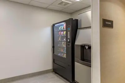 a vending machine in a room with a drink cooler at Comfort Inn & Suites Hadley - Amherst in Hadley
