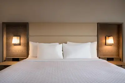 a bed with white pillows in a hotel room at Crowne Plaza Englewood by IHG in Englewood