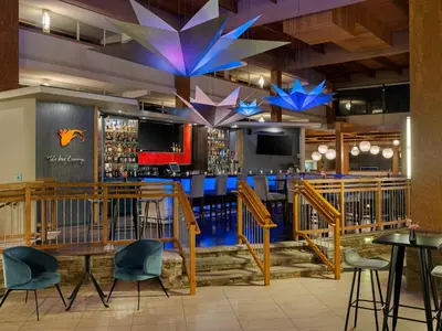 a bar in a restaurant with tables and chairs at Crowne Plaza Suffern-Mahwah by IHG in Suffern