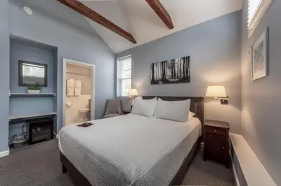 a bedroom with a bed and a fireplace at Homestead Inn in New Milford