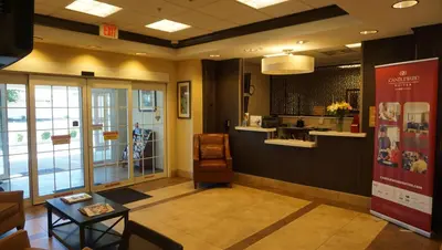 a lobby of a store with a table and a counter at Candlewood Suites-West Springfield by IHG in West Springfield