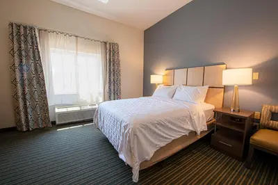a hotel room with a bed and a window at Candlewood Suites-West Springfield by IHG in West Springfield